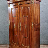 Louis Philippe period wardrobe (nineteenth) entirely covered with gilded bronzes