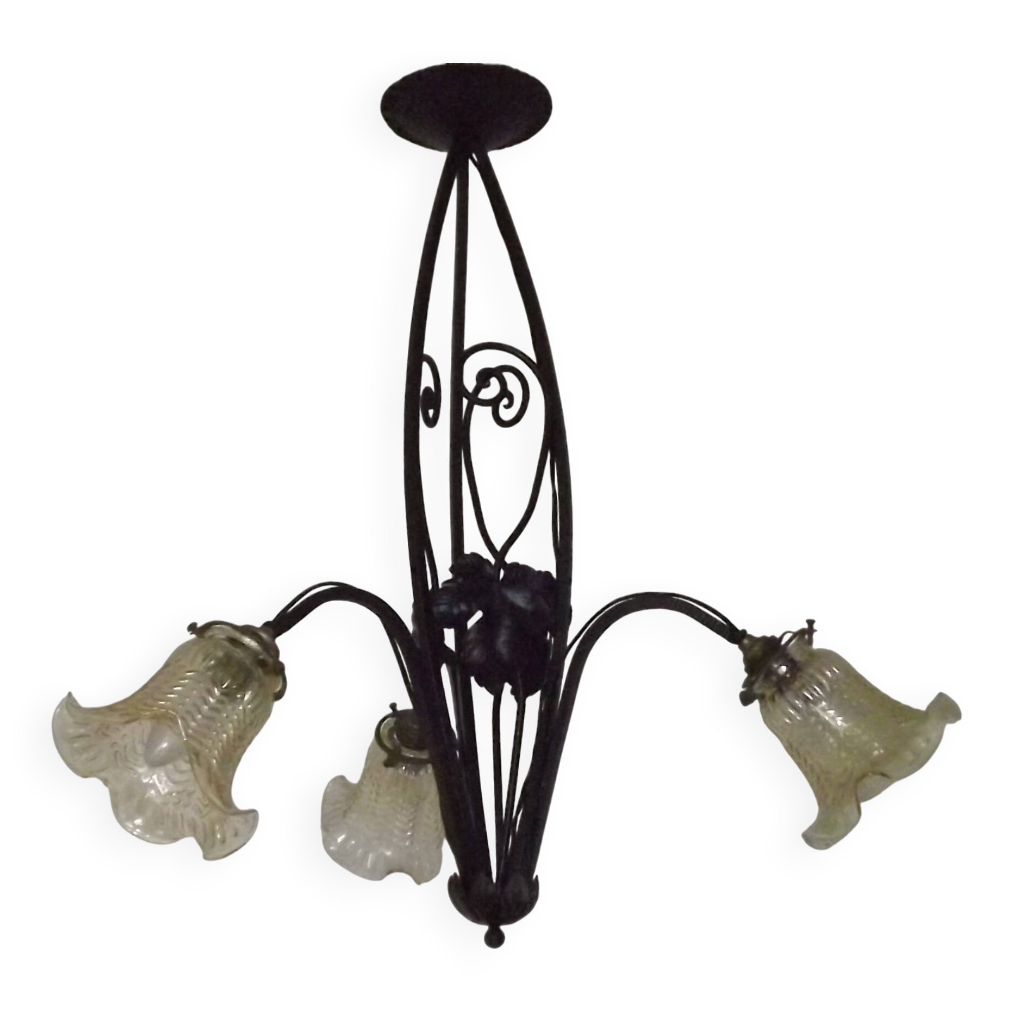 French Art Nouveau leaf detail iron three-light chandelier with amber glass shades.