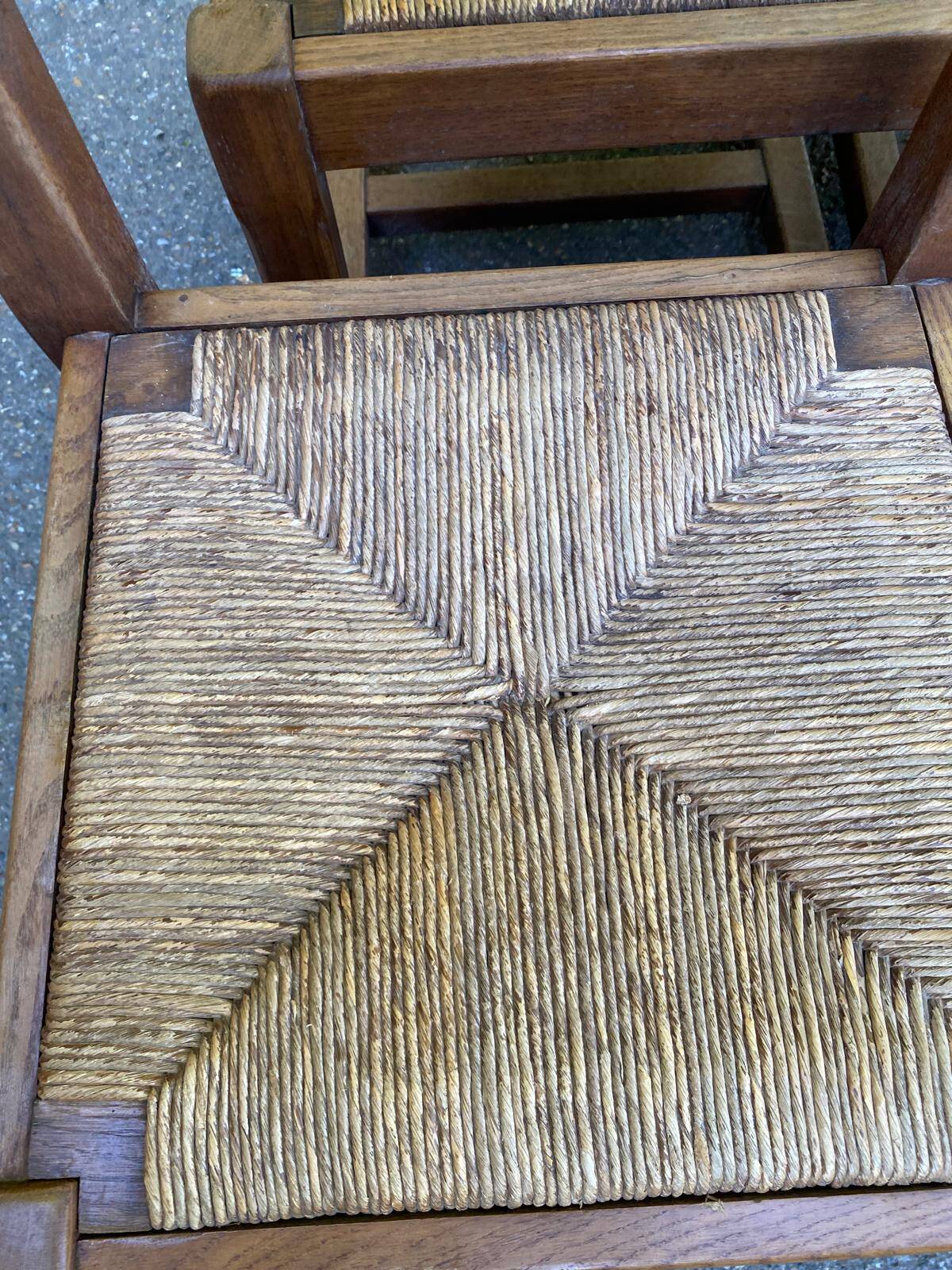 6 solid oak chairs with rush seats in a country style.