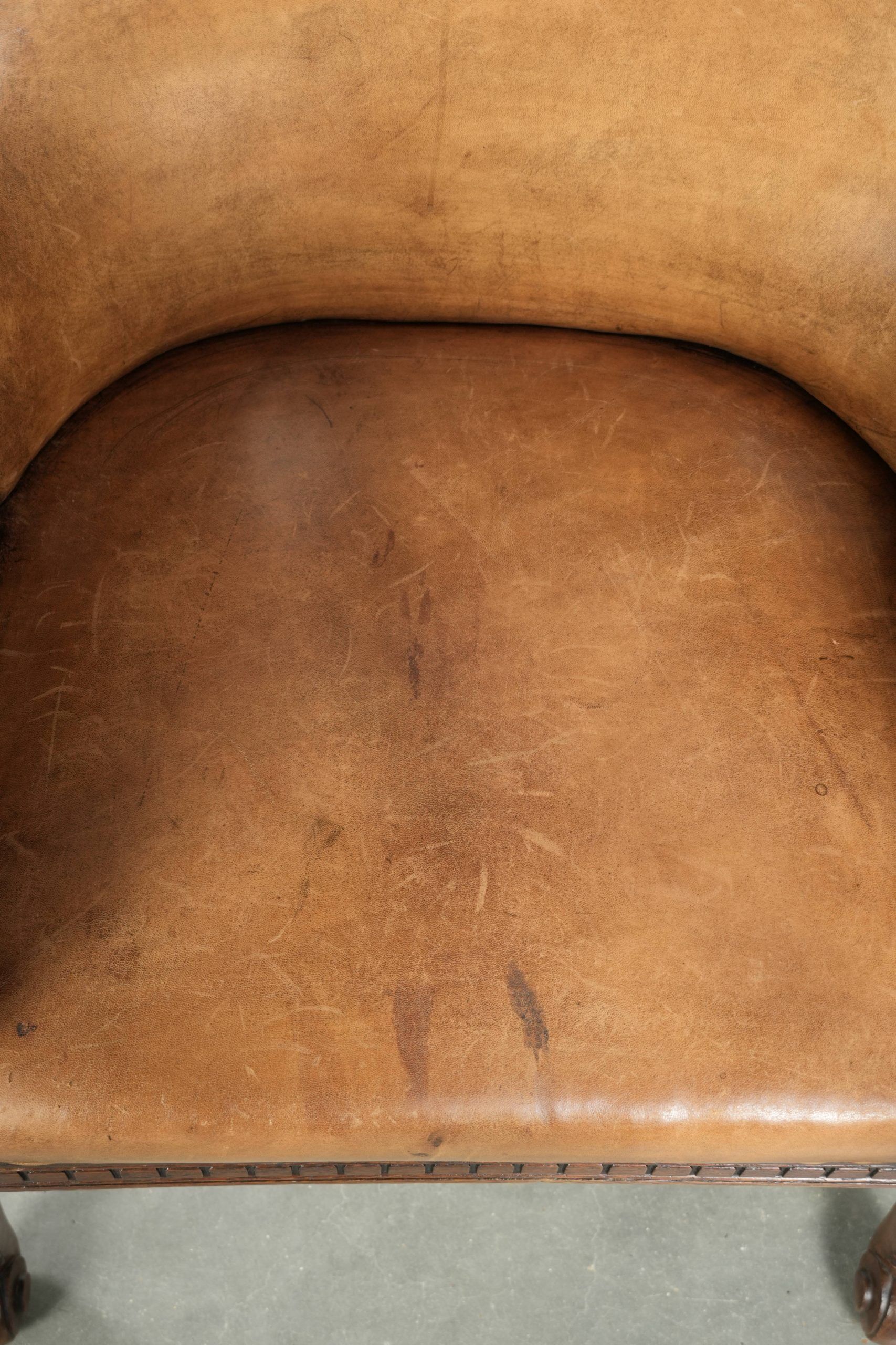 Antique armchair made of sheepskin and wood with decorative nails