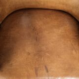 Antique armchair made of sheepskin and wood with decorative nails
