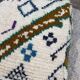 Berber floor pouf: Handwoven Moroccan wool cushion.