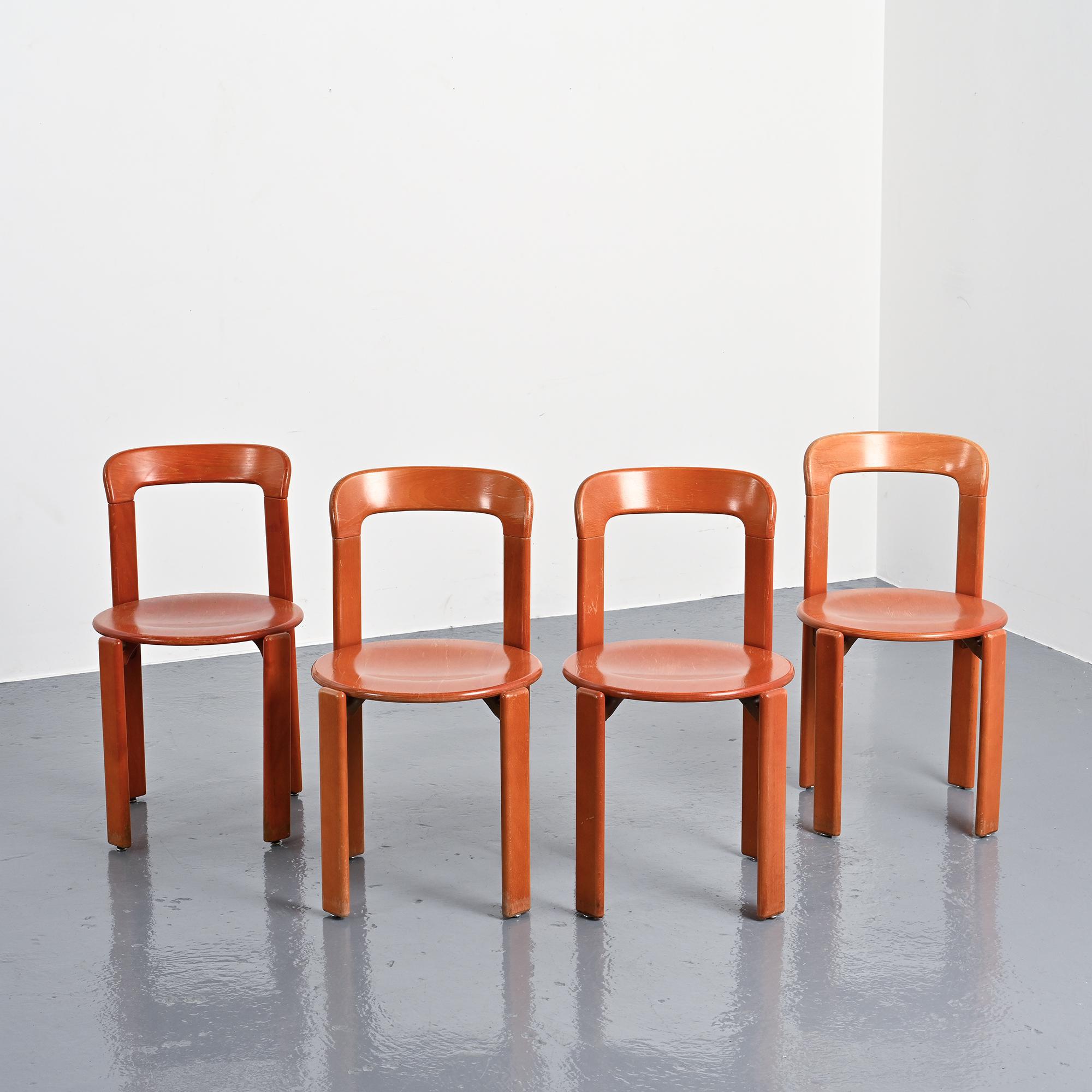 Rey chairs in stained red beech by Bruno Rey