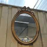 Louis XVI-style oval mirror in gilded stucco circa 1900