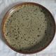 Round dish in varnished sandstone