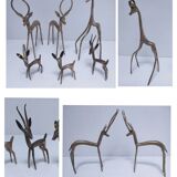 five vintage brass sculptures of gazelles, antelopes, and a giraffe