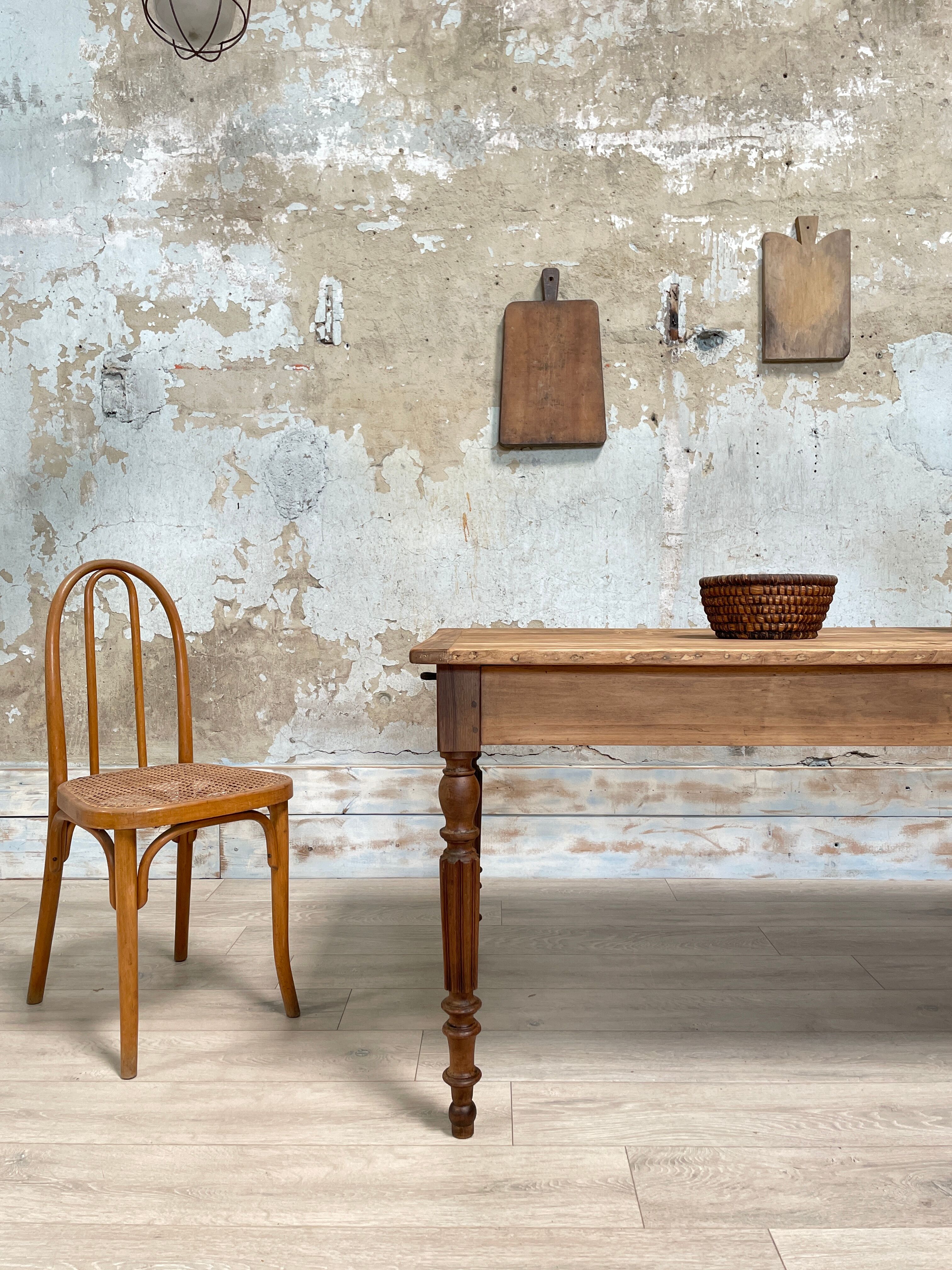 Vintage farmhouse table with turned legs.
