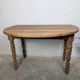 Antique wooden drop-leaf table with turned legs.