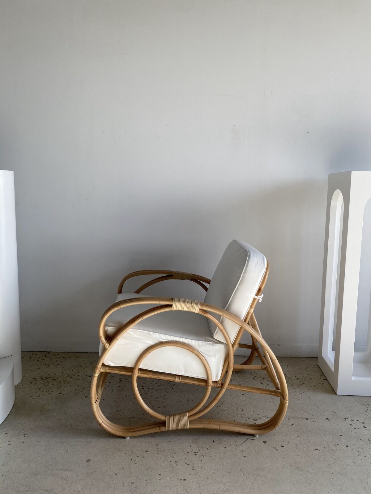 Large rattan rest chair and white cushions