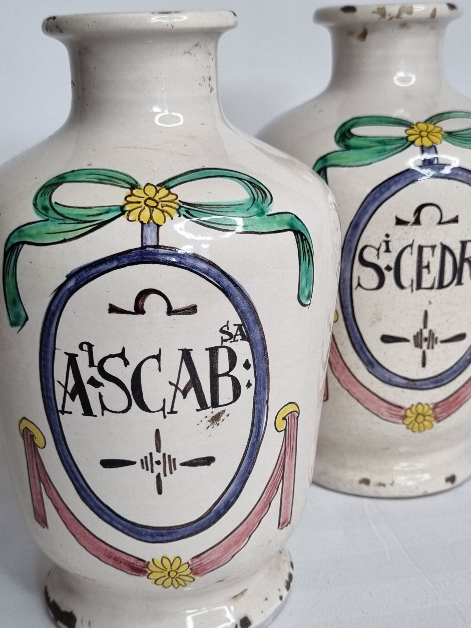 Pair of antique apothecary pots in glazed ceramic, decorated by hand