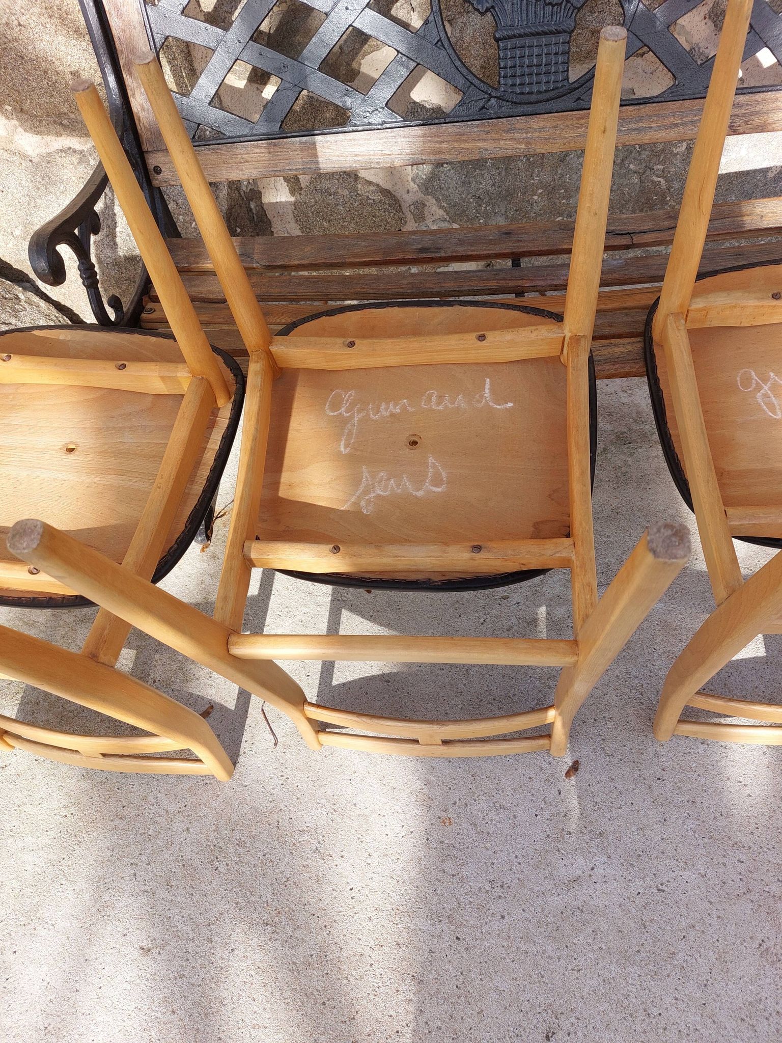 3 Scandinavian style chairs, light wood and black faux leather.
