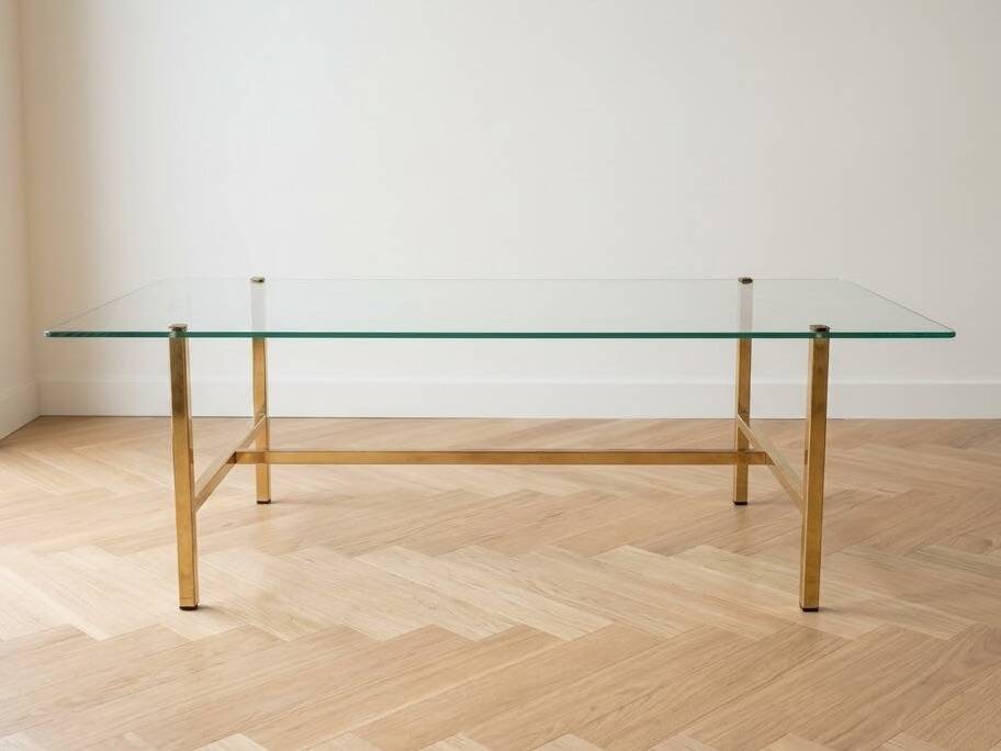 Vintage coffee table with glass and gold metal.