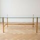 Vintage coffee table with glass and gold metal.