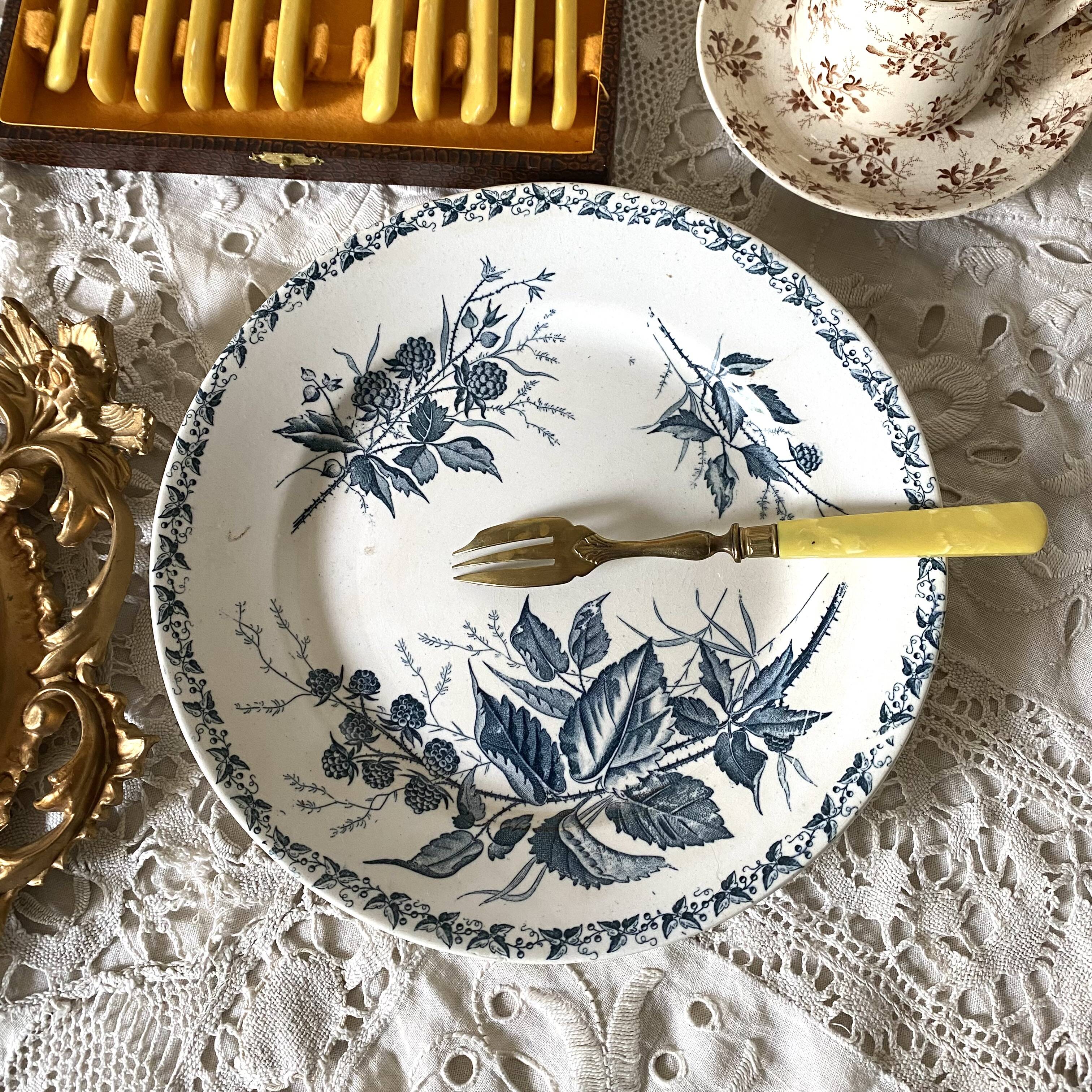 Antique dessert forks in brass and bakelite
