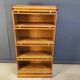 Four tier oak barrister style bookcase with leaded glass