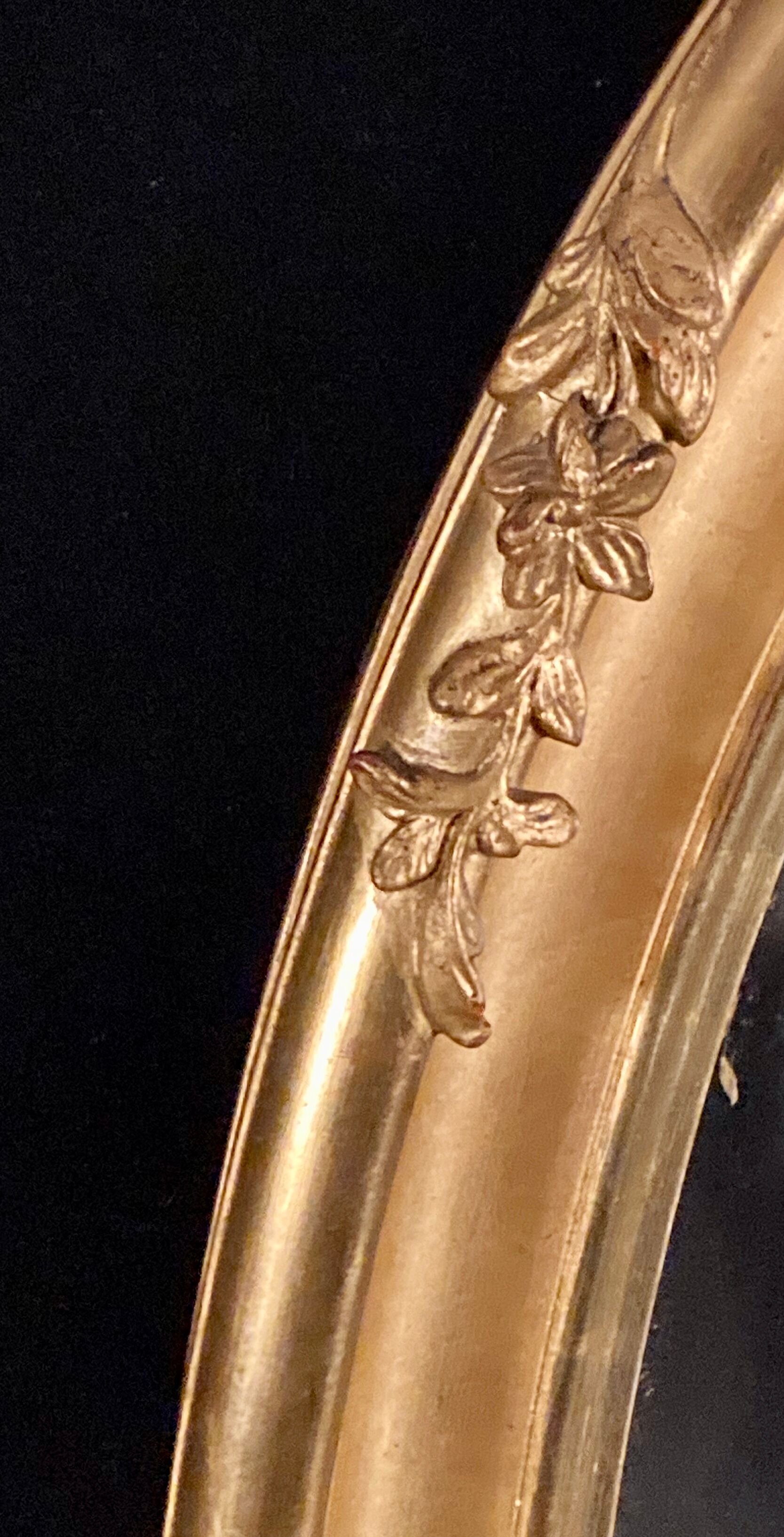 Large oval mirror in gilded wood