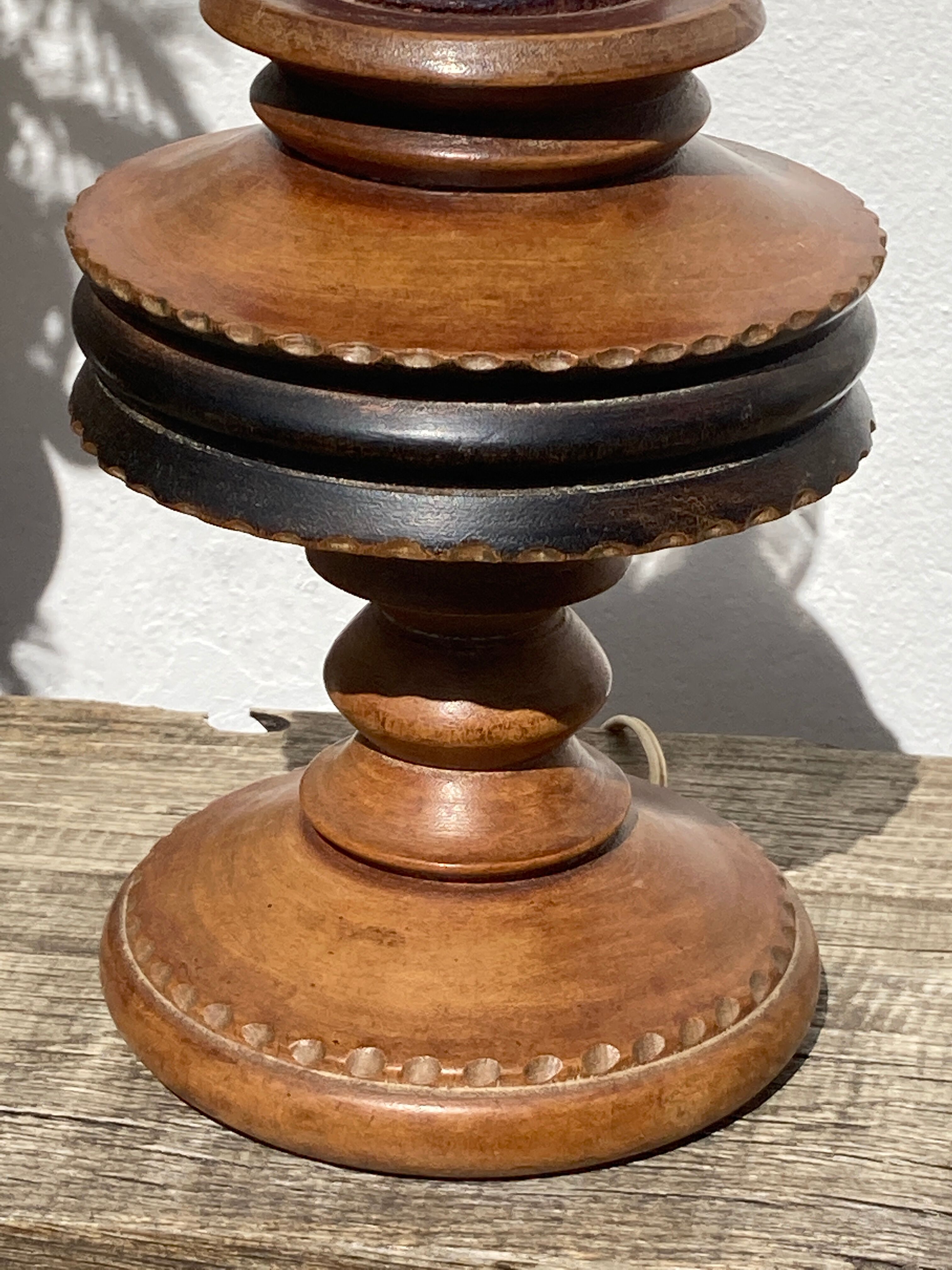 Foot of turned wooden lamp and carved