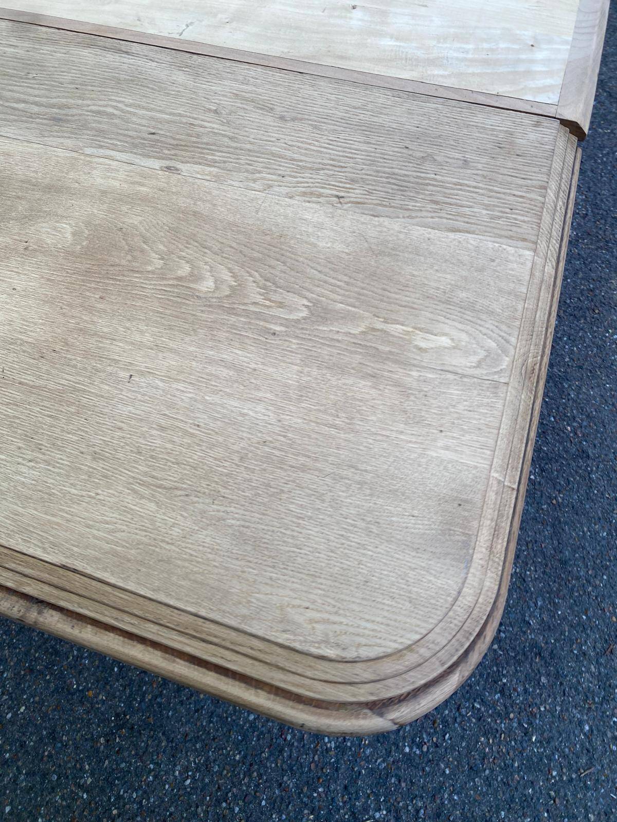 Art Deco dining table with a central pedestal, stripped in solid oak, with 2 extensions.