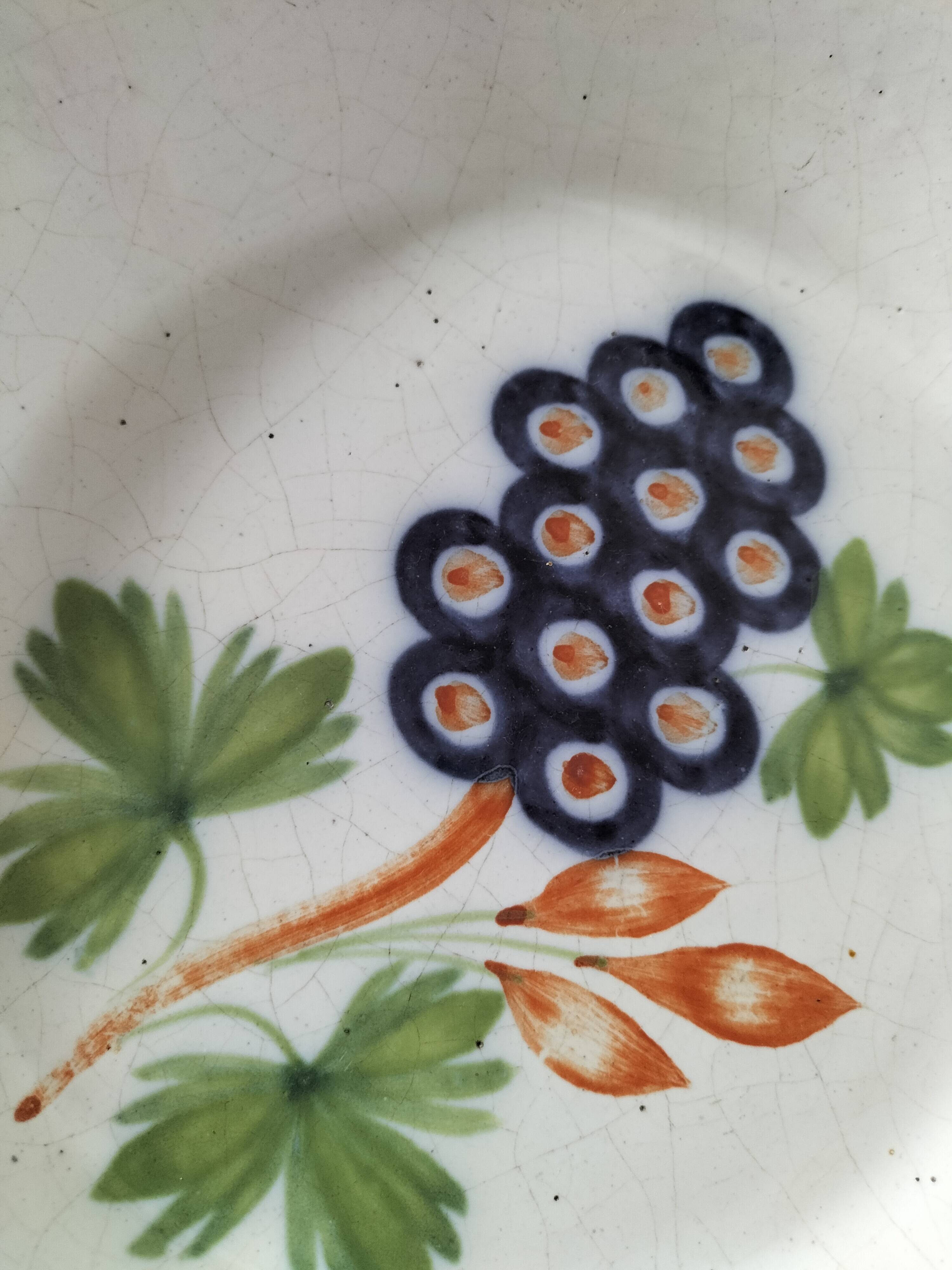 Pair of antique soup plates with hand-painted grape decoration