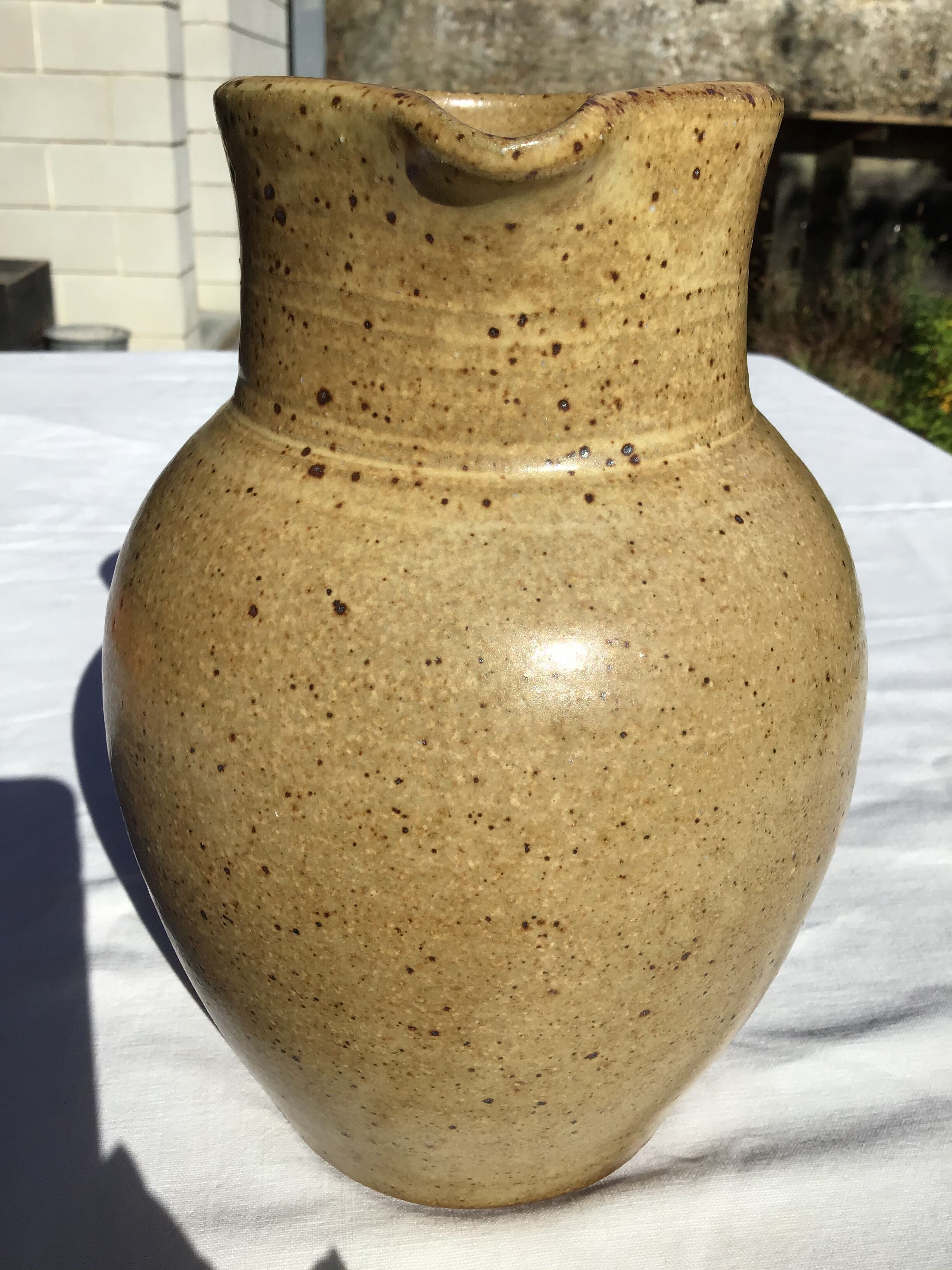 Beige handcrafted speckled sandstone pitcher