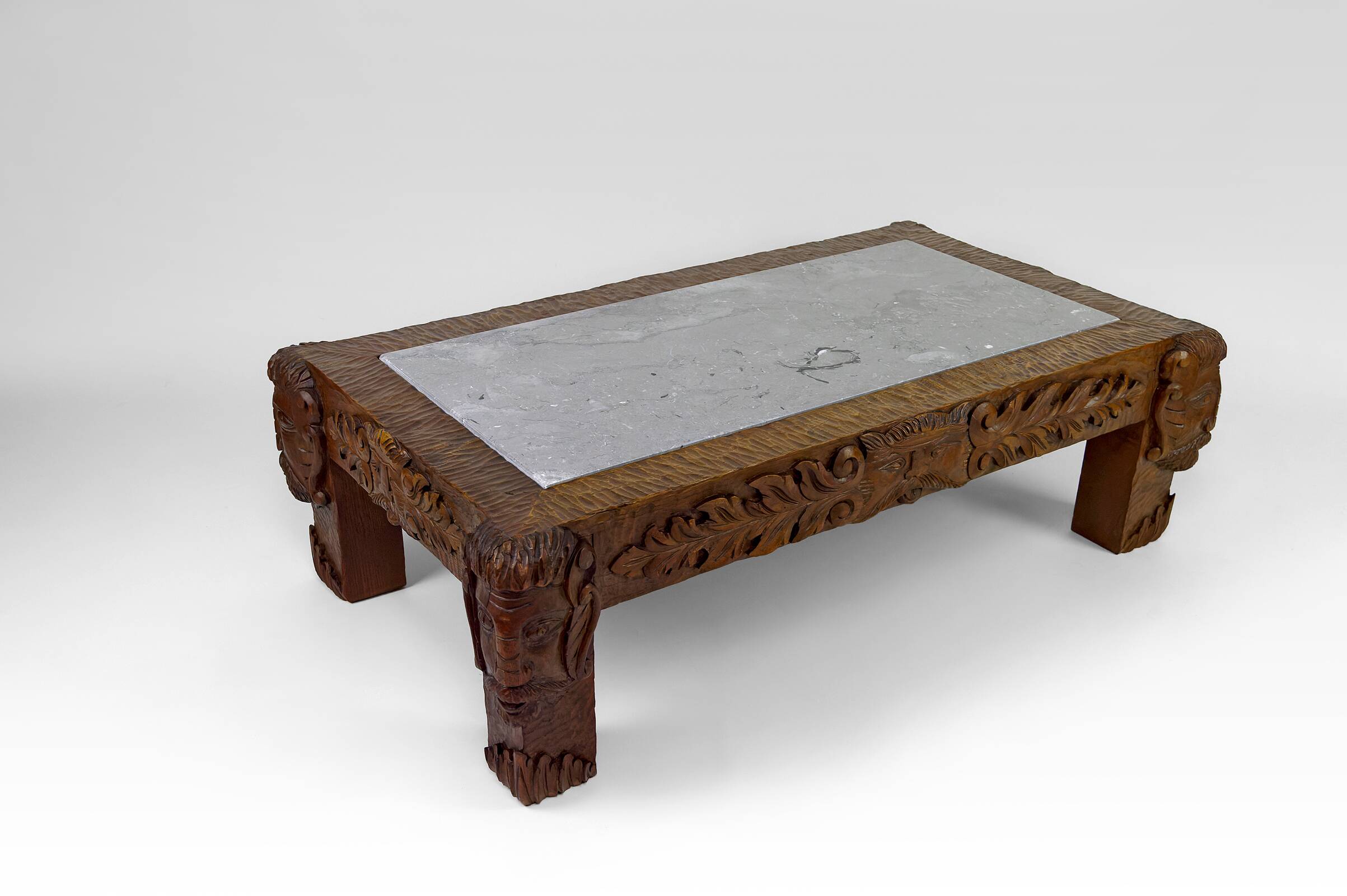Solid oak coffee table carved with fauns and gray marble top, France, circa 1940