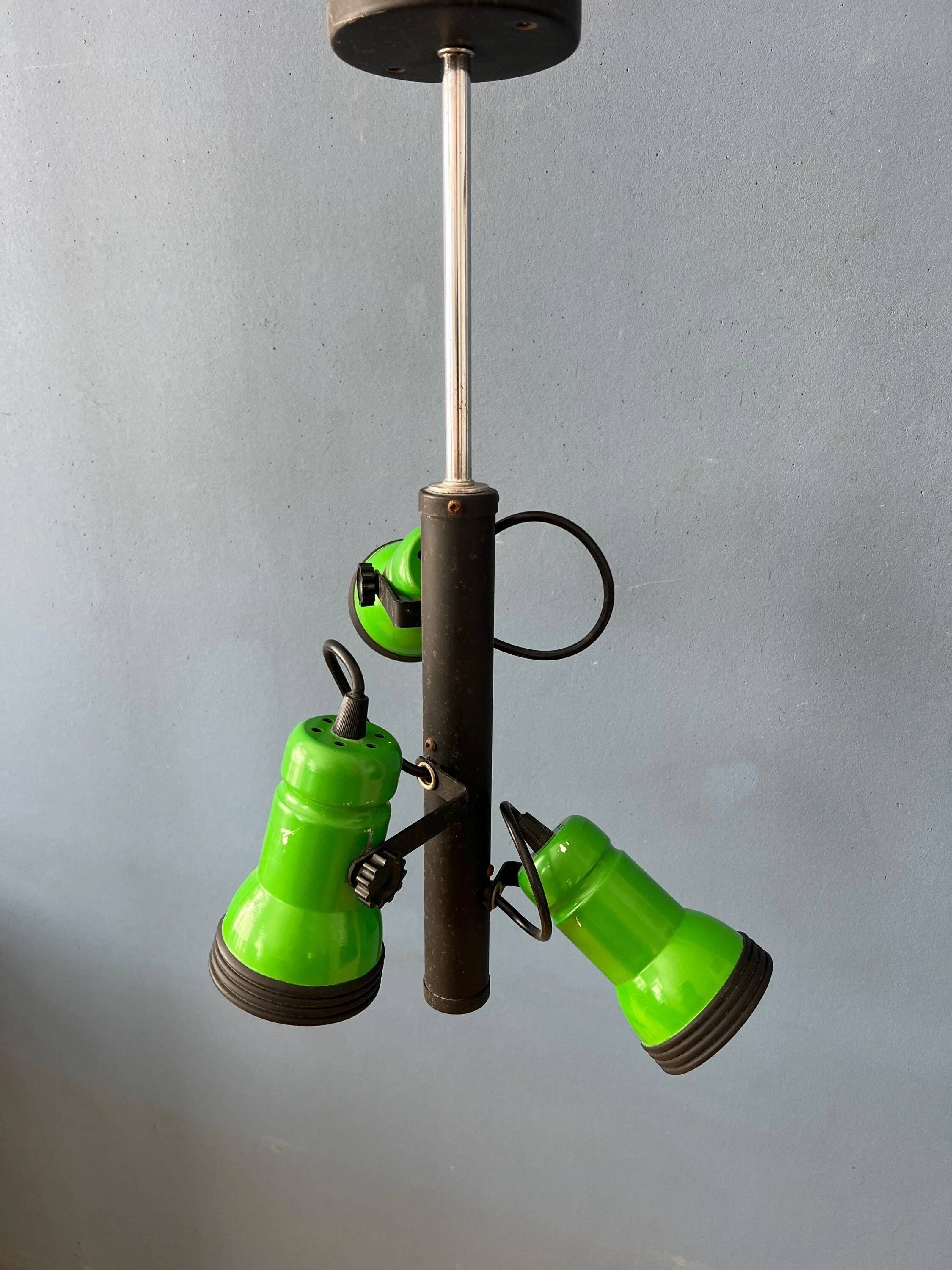 Vintage pendant light with three green spots.