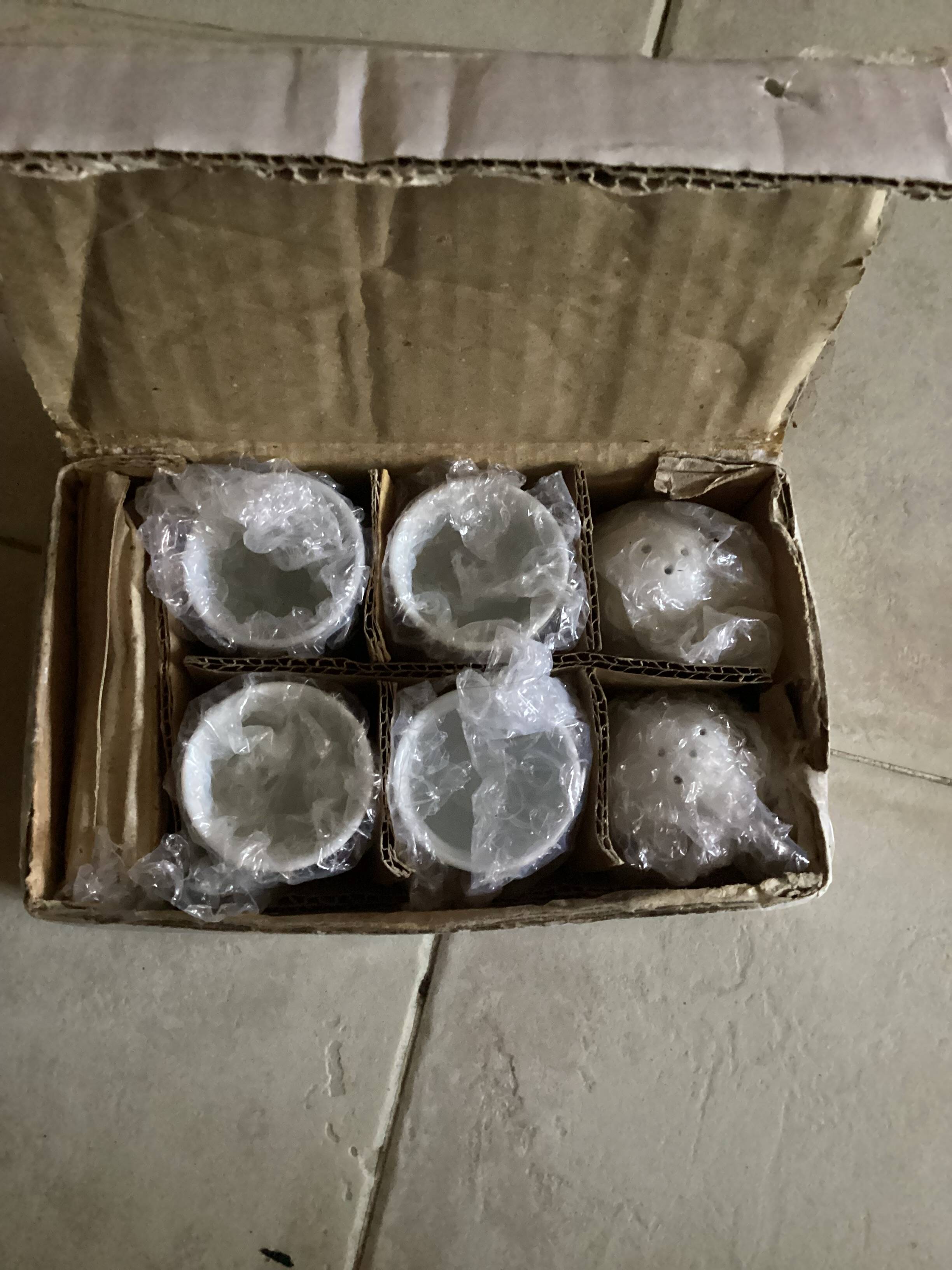 Set of 4 egg cups with their spoons, salt shaker, colored pepper shaker