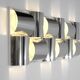 Contemporary wall light in stainless steel and metal.
