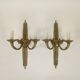 Pair of two-armed Empire wall sconces in gilded bronze