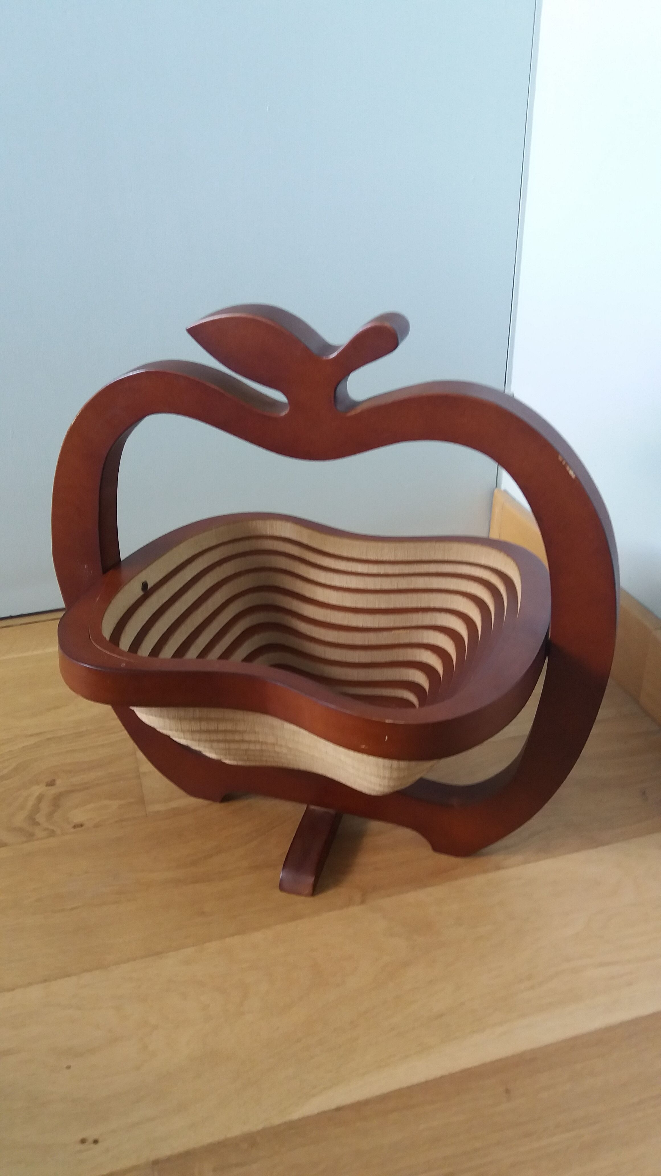 Foldable fruit basket in the shape of an apple.