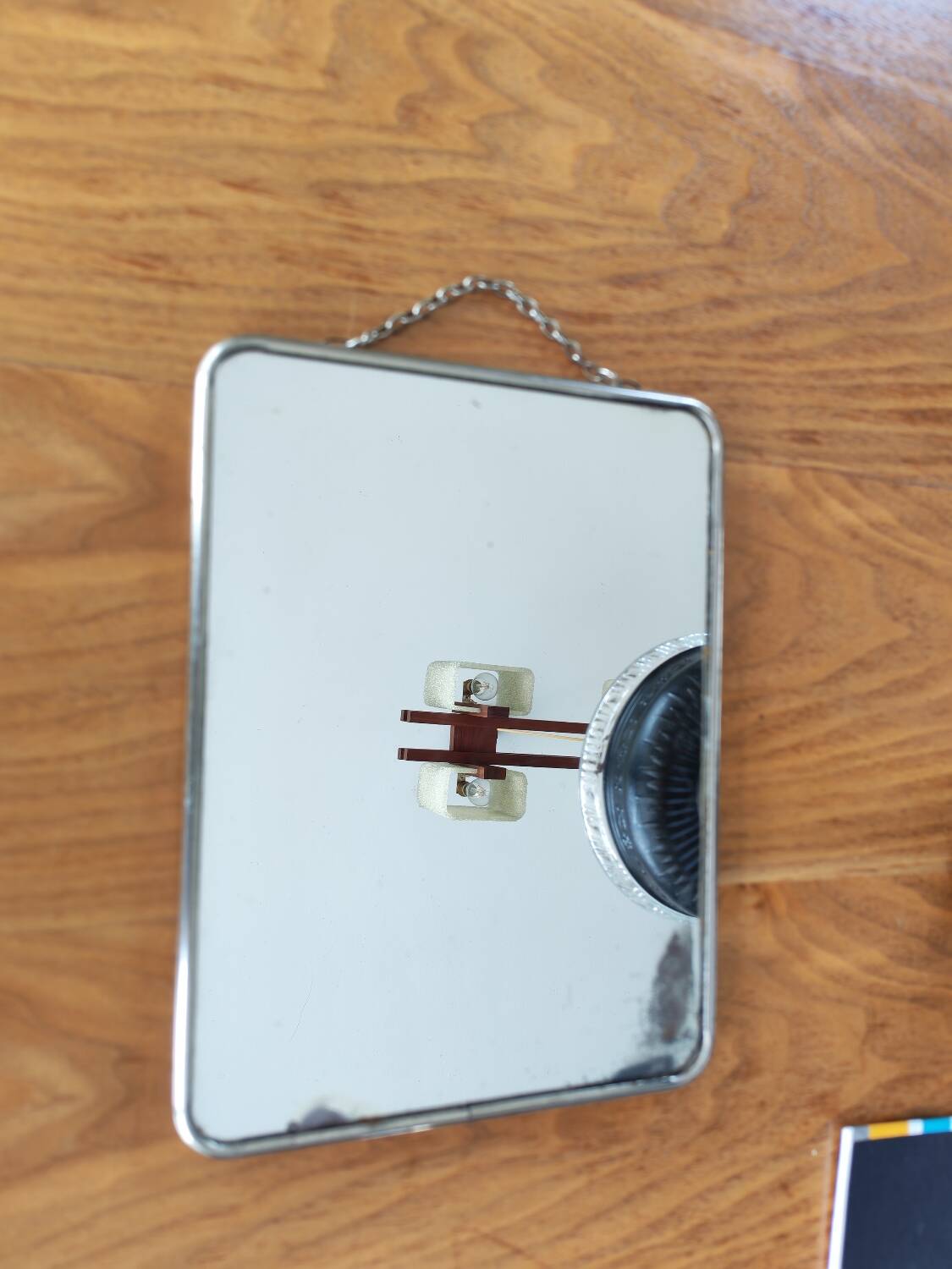 Vintage barber mirror with chain.