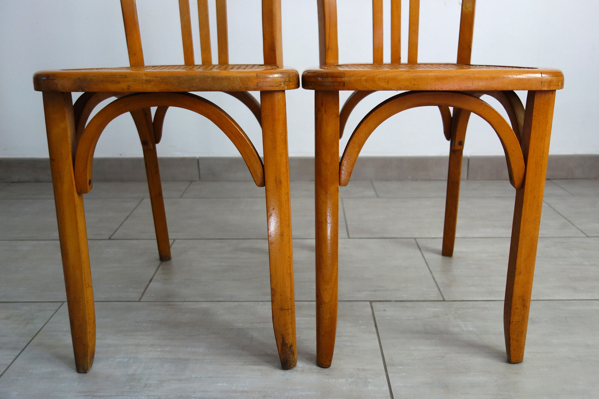 Pair of stella caned bistro chairs, 1930s
