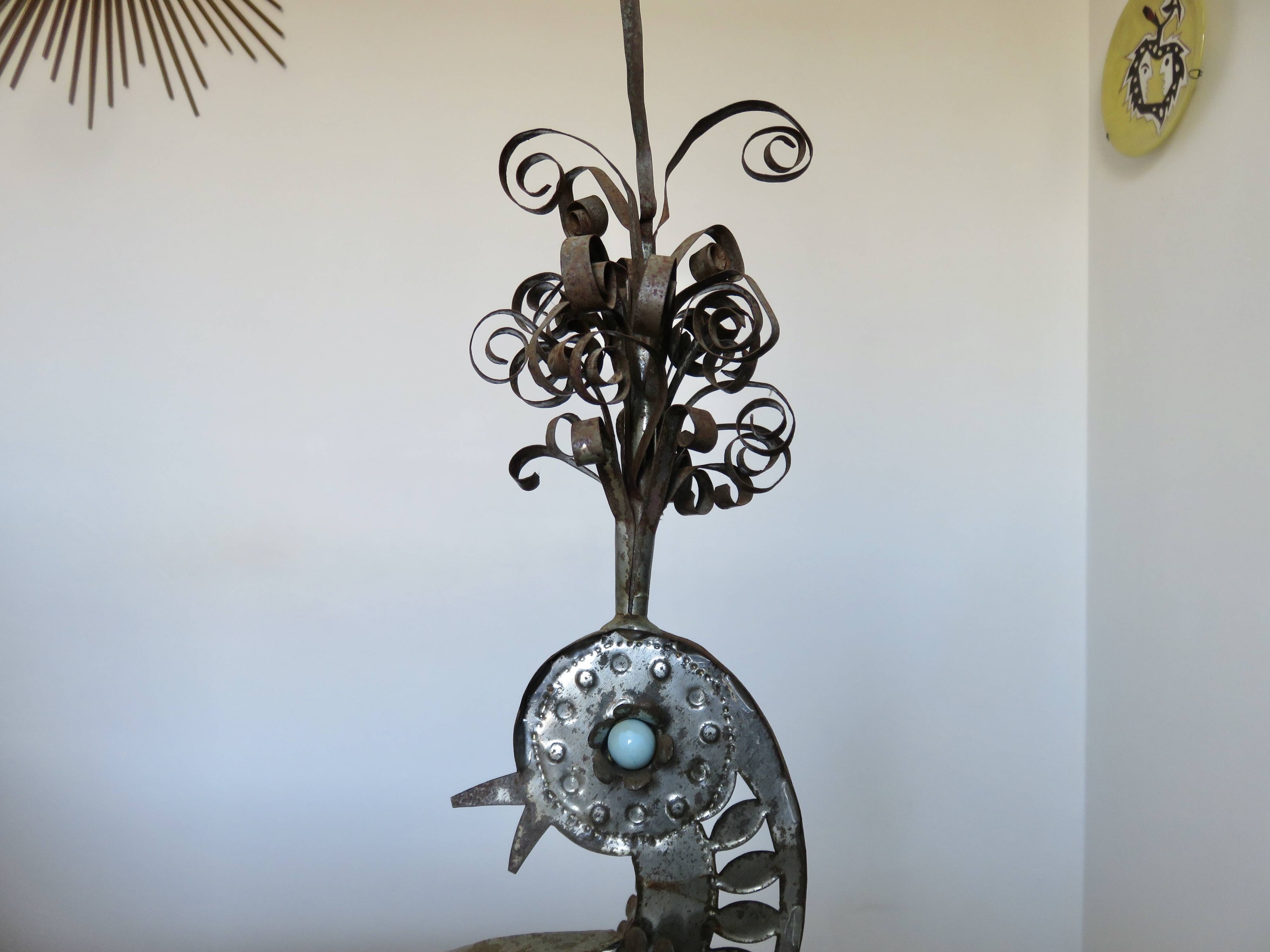 metal sculpture in sheet metal representing a peacock, work from the 1960s