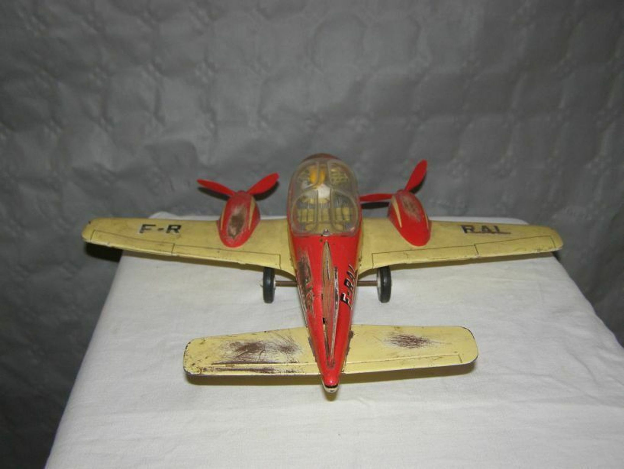 Old metal Joustra toy; propeller aircraft with its pilot friction mechanism