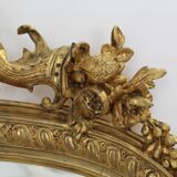 Large 19th-century wooden and gilt-studded mirror decorated with a cornucopia motif.