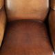 Sheepskin wingback armchair with patina finished with decorative nails