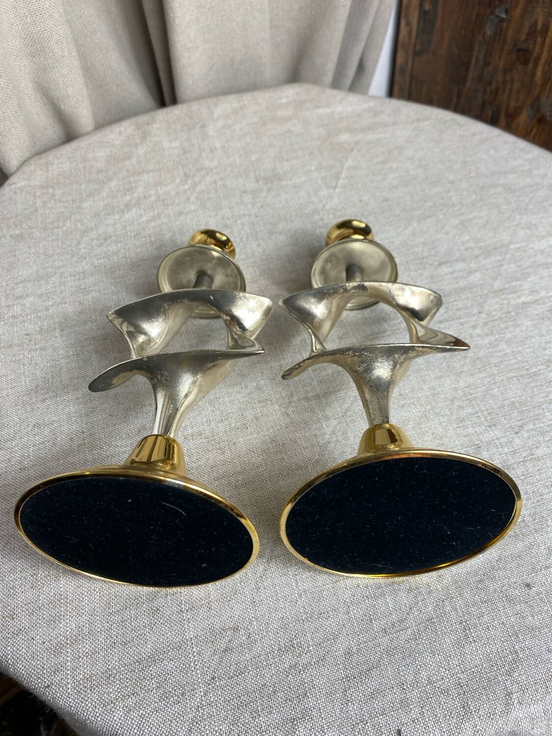 Pair of silver and gold metal candlesticks