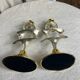 Pair of silver and gold metal candlesticks