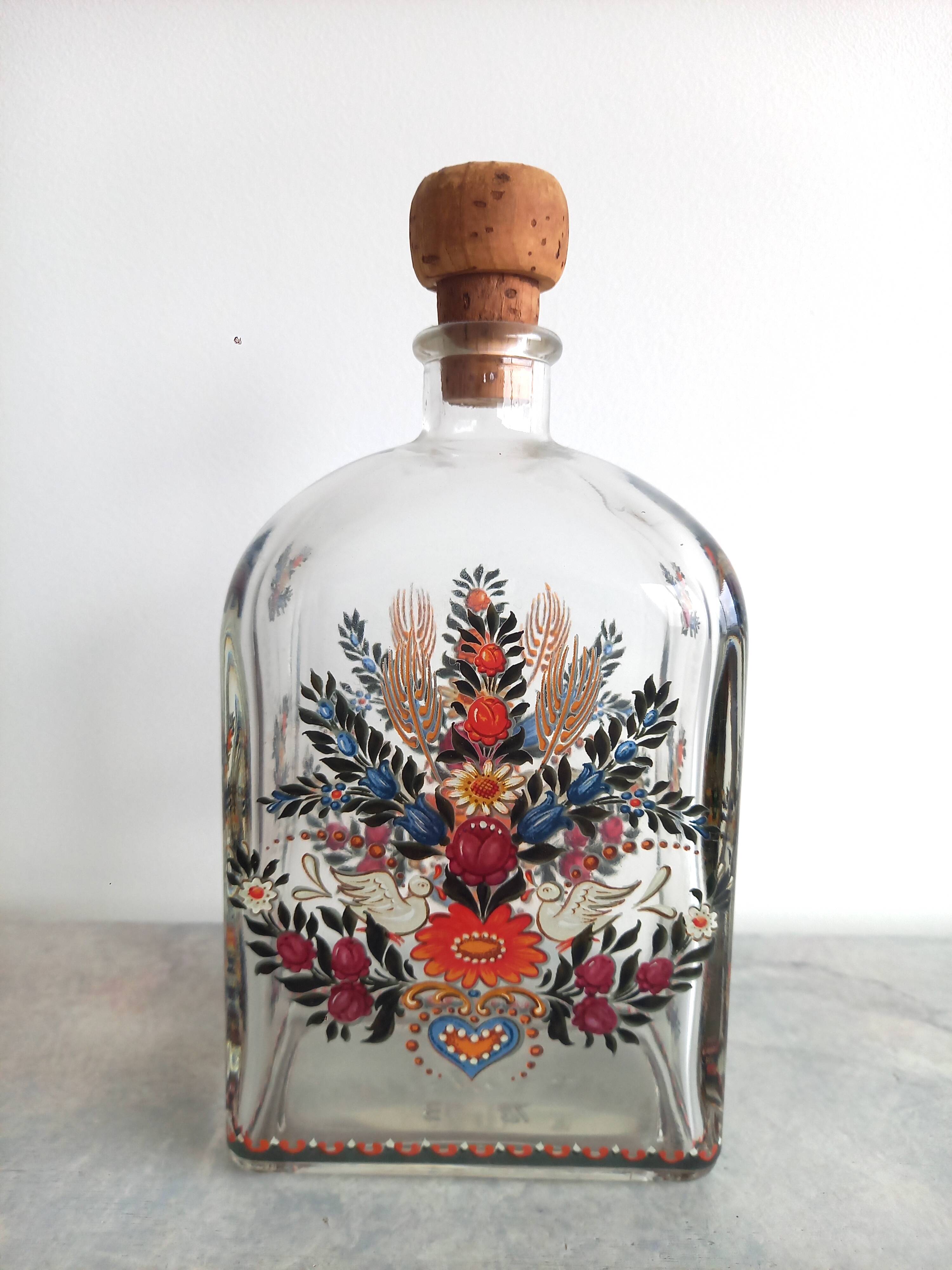 Bottle with folkloric decoration of flowers and birds inspired by Eastern countries