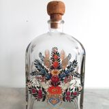Bottle with folkloric decoration of flowers and birds inspired by Eastern countries