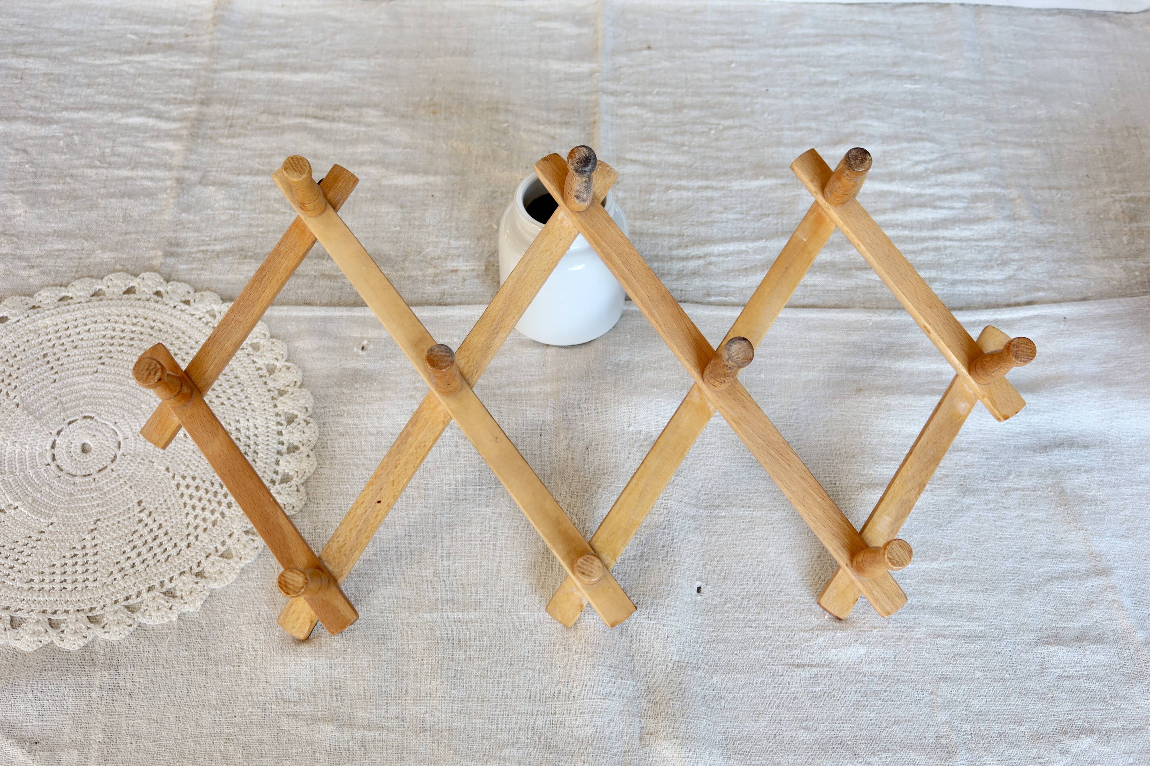 Vintage retractable wall-mounted coat rack made of pine wood