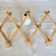 Vintage retractable wall-mounted coat rack made of pine wood