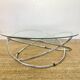 Coffee table with glass top and chrome tubular base