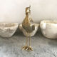 Crested bird in golden brass