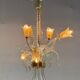 Asymmetrical Venetian chandelier in colourless and gold Murano glass, circa 1980.
