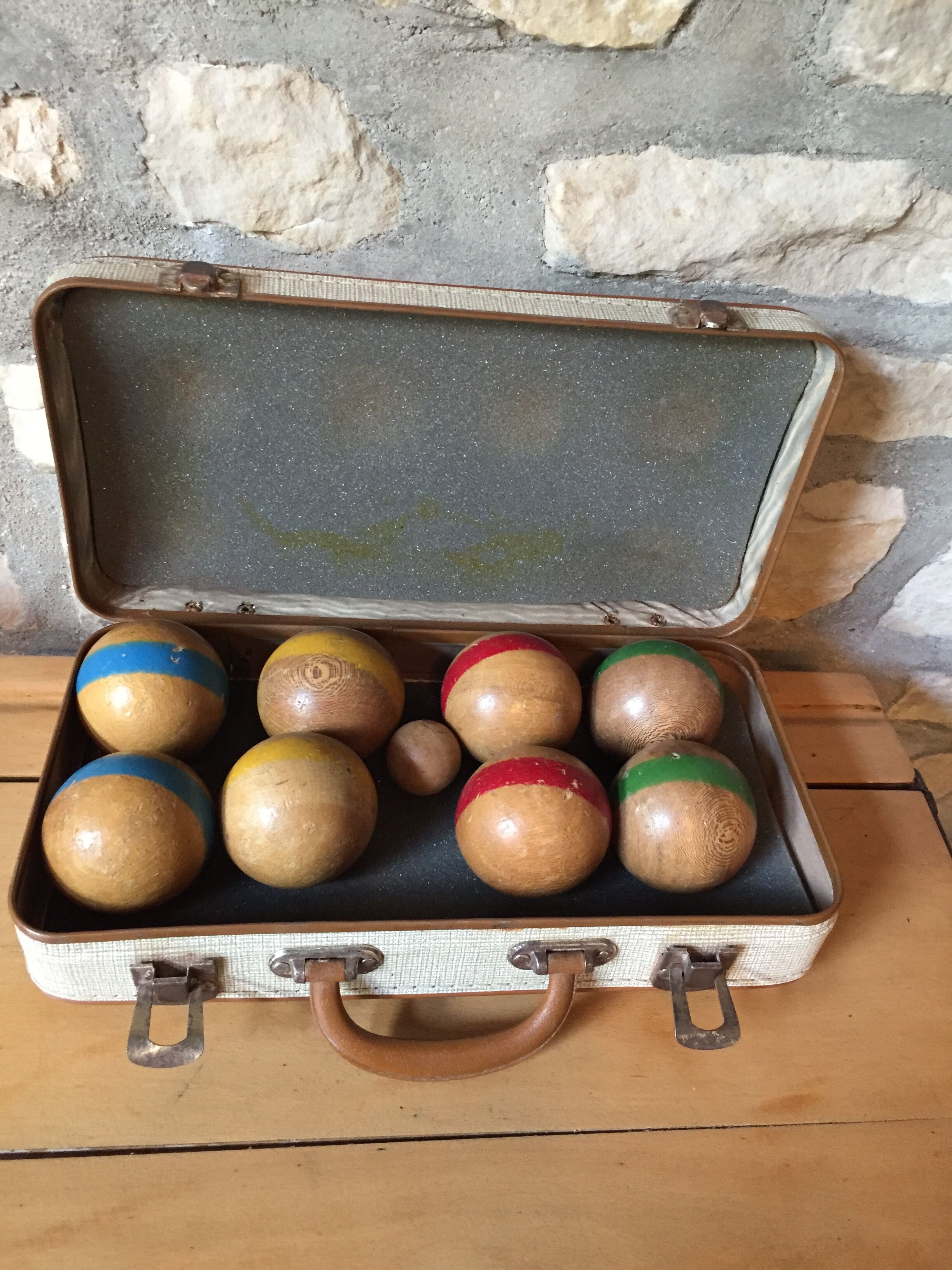 Old set of wooden balls in his suitcase