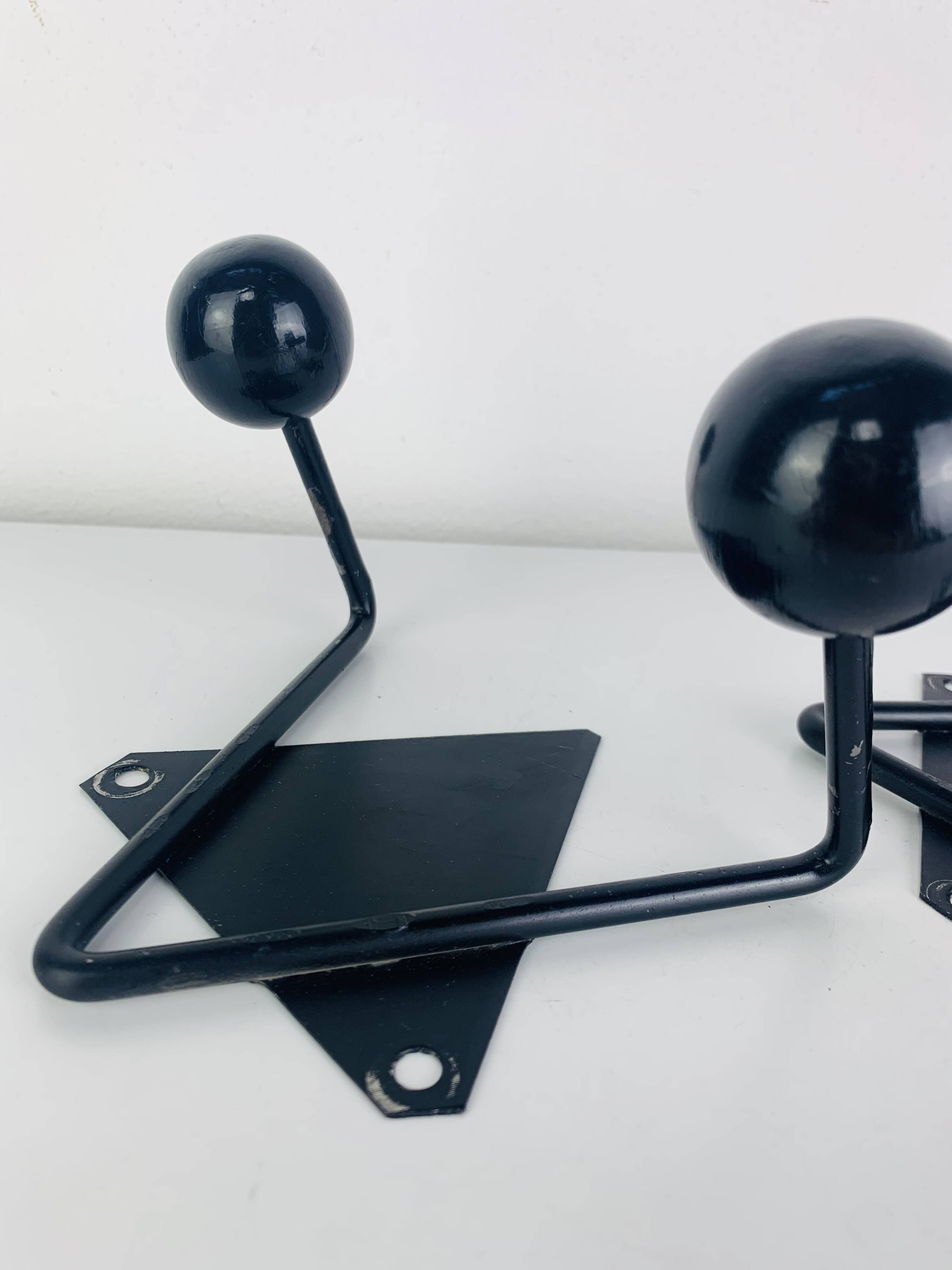 Pair of wall hooks from the 1950s, black metal