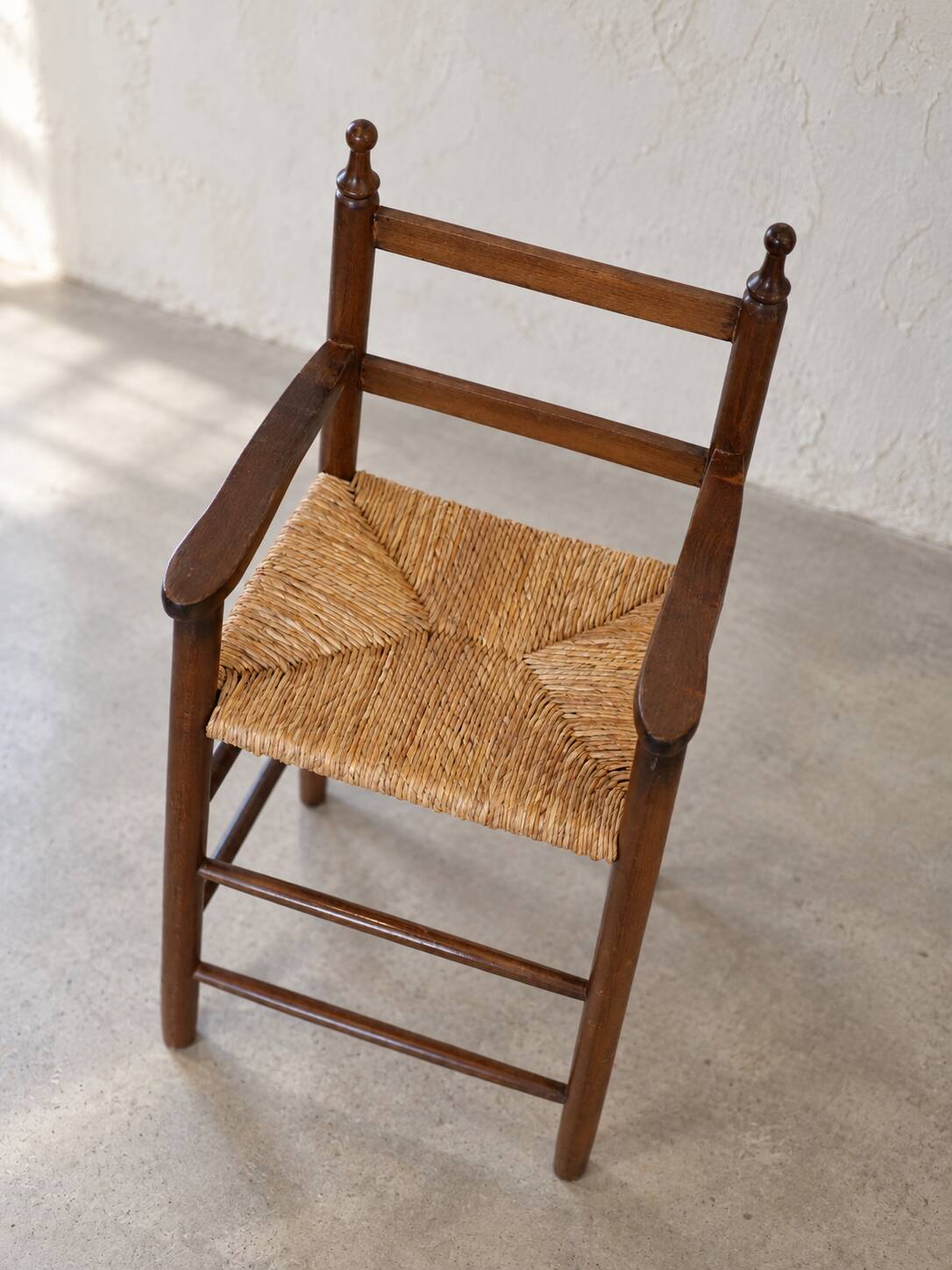 High chair made of straw and wood