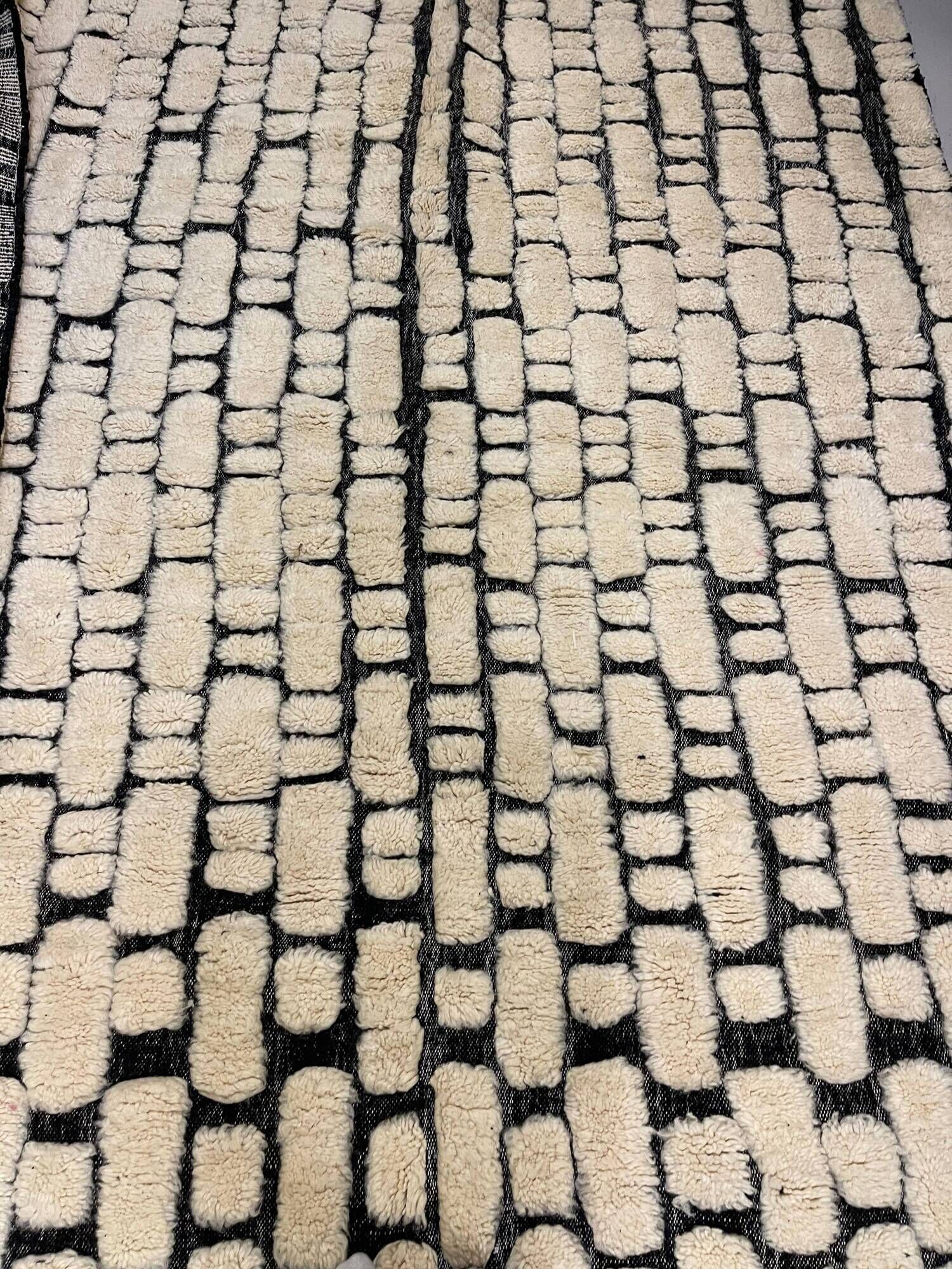 Large cream and black checked Berber rug, 280 × 200 cm.