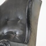 Antique black English cow leather wingback armchair from the 19th century
